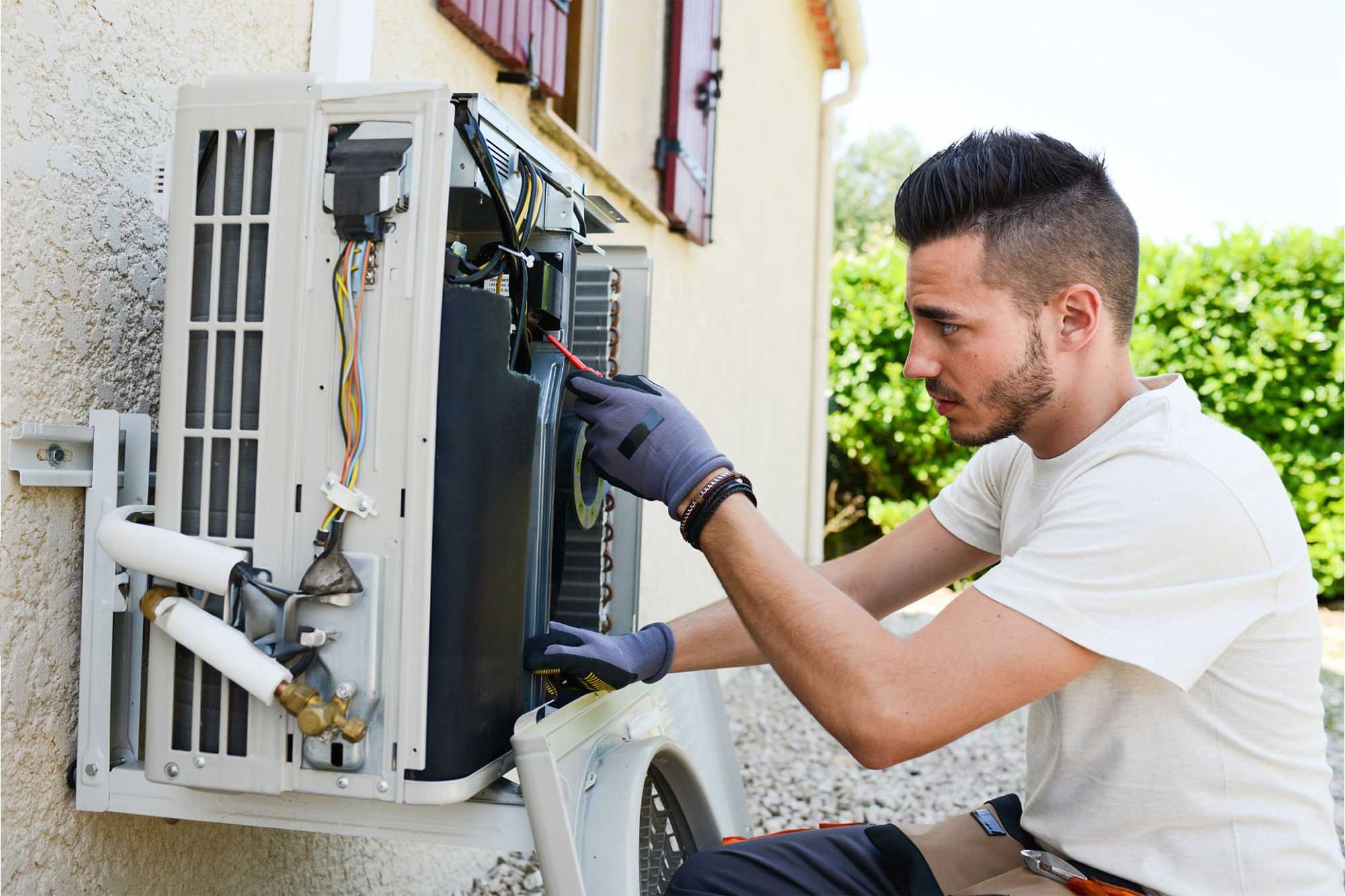 Sunshine Air Conditioning technician servicing an outdoor AC unit at a South Florida home