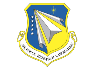 Emblem of the Air Force Research Laboratory featuring a stylized paper airplane, stars, and a radiant star, with a banner reading 'Air Force Research Laboratory'.