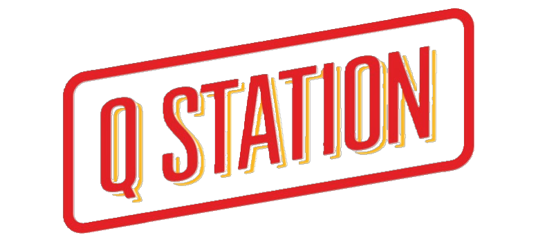 Neon sign reading 'Q STATION' in red, yellow, and blue colors.