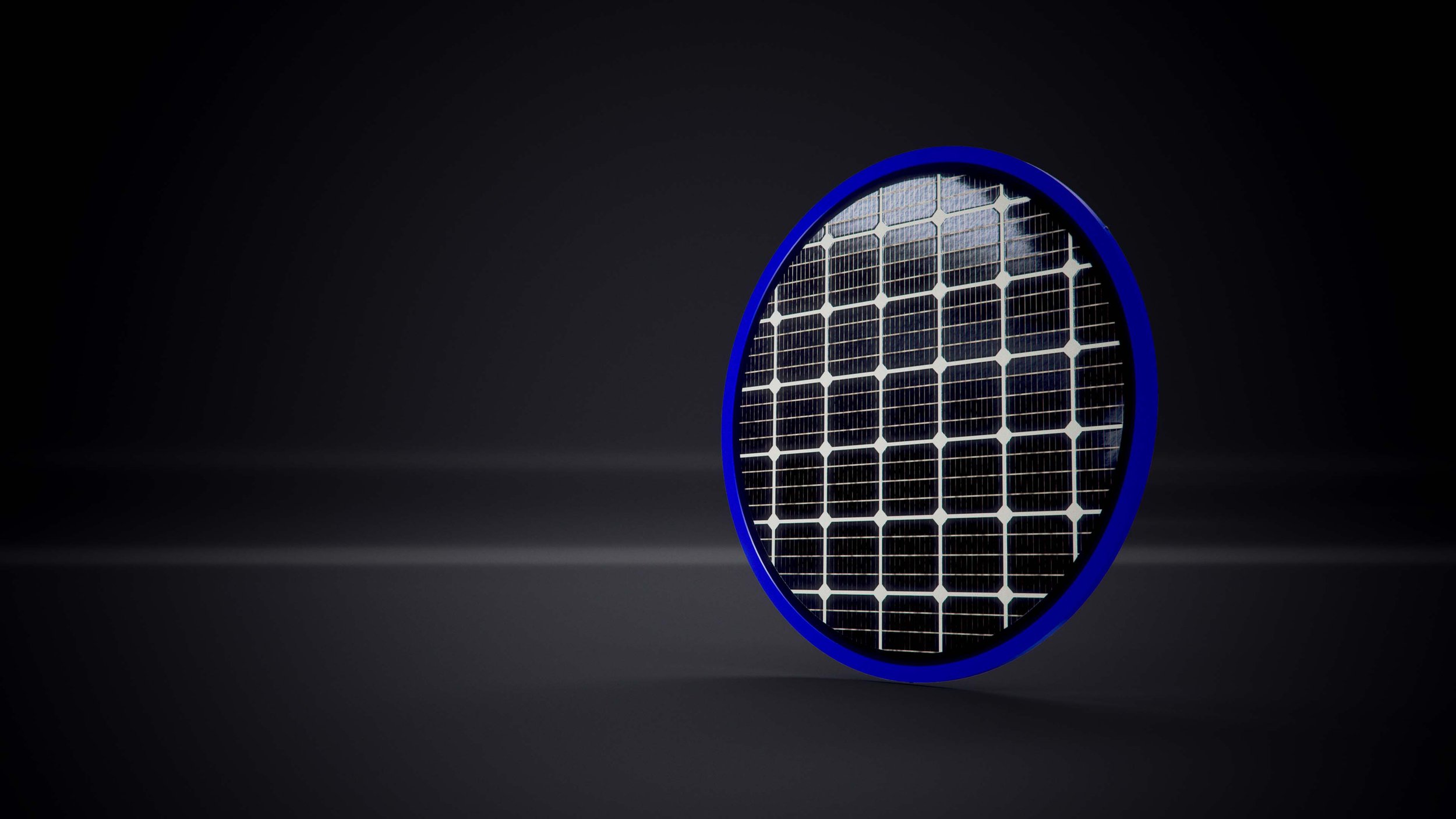 A close-up of a solar panel with a blue circular frame, illuminated against a dark background.